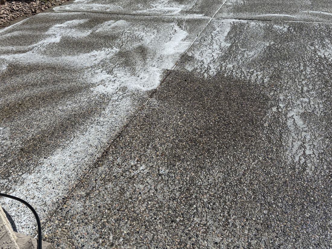 Cleaning solution being applied to a driveway during a Summit Property Care job