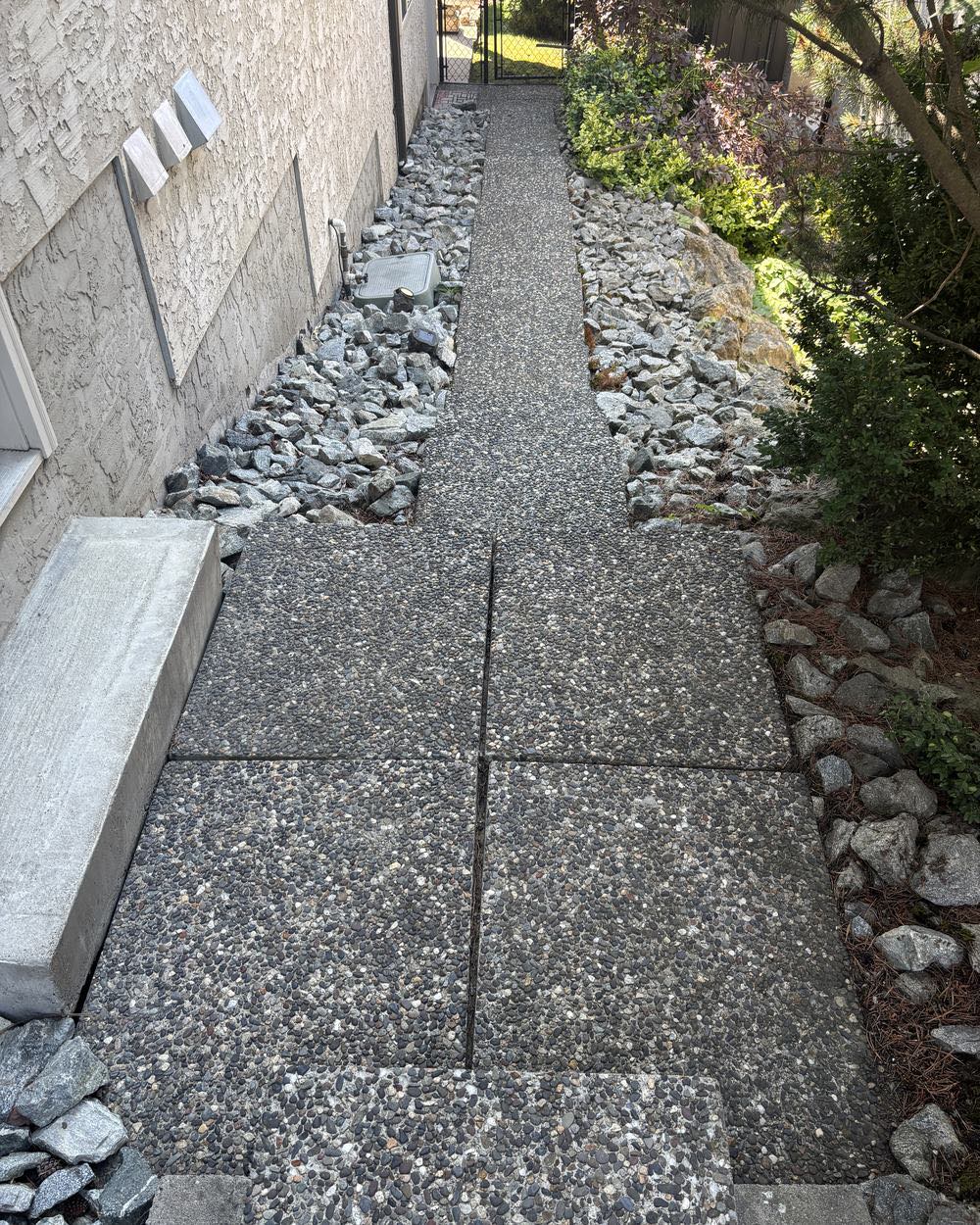 A cleaned aggregate walkway and retaining wall at an Okanagan property